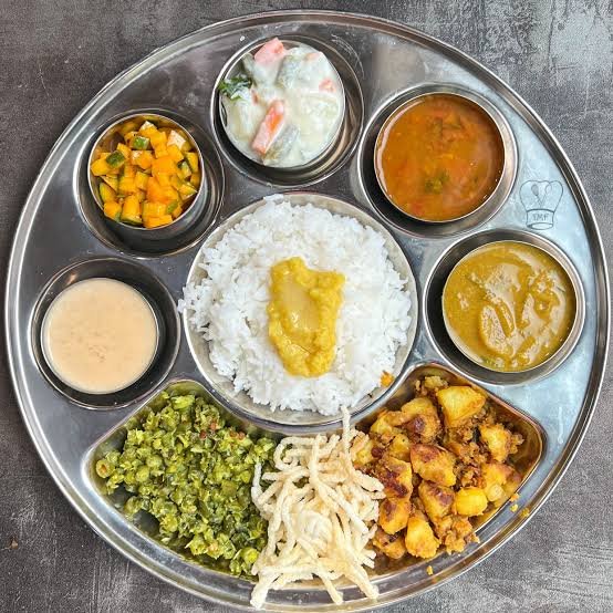 Veg thali with rice, dal, curries and raita